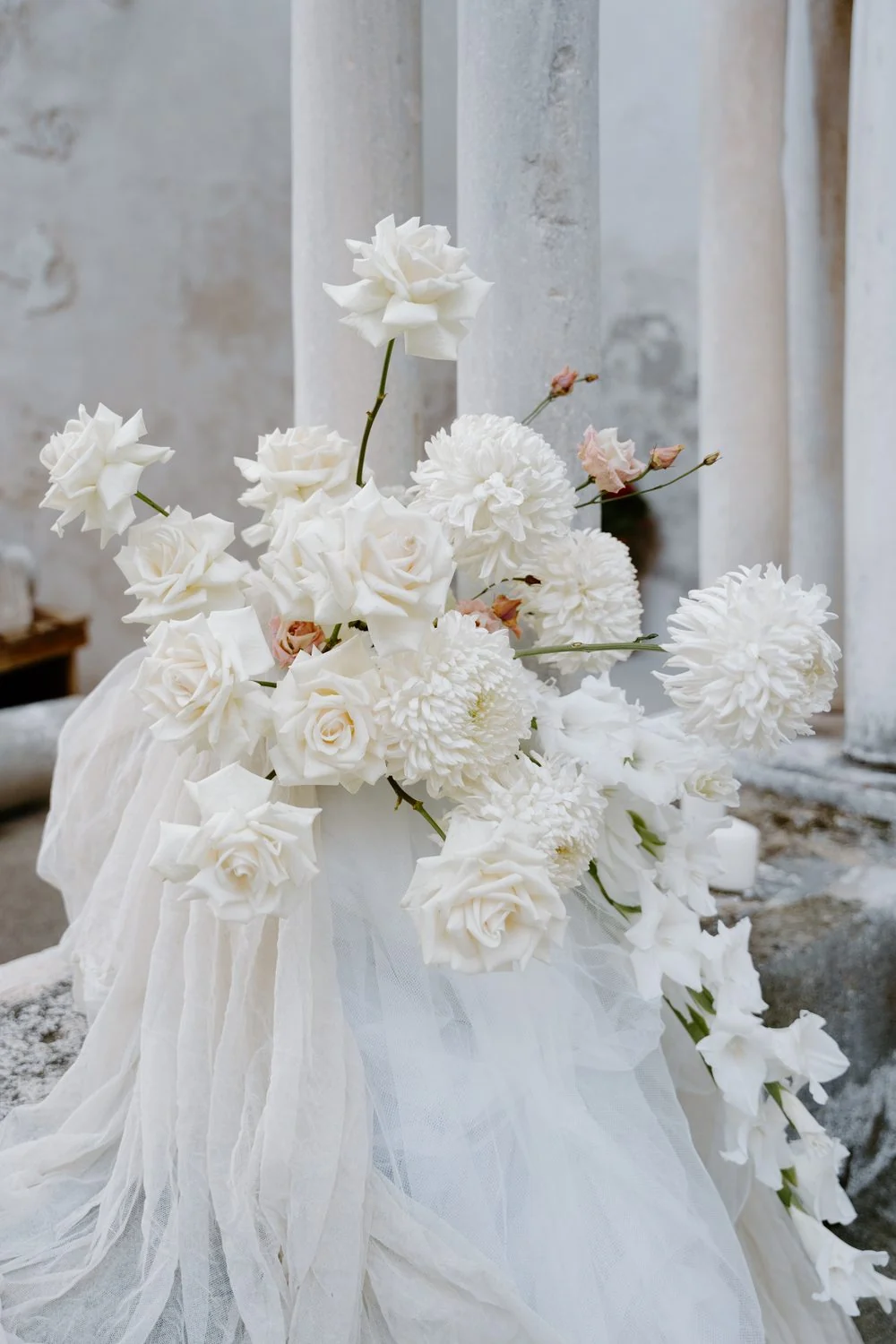 Reception table set with candles and a running floral centrepiece